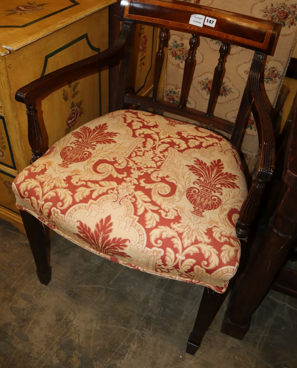 A Sheraton style satinwood banded mahogany elbow chair